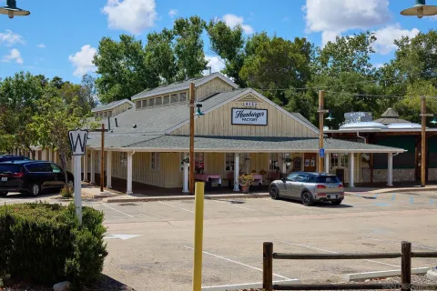 a view of a building with street view and trees