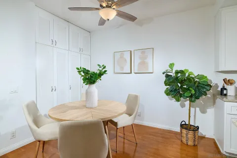 a view of a dining room with furniture and a potted plant