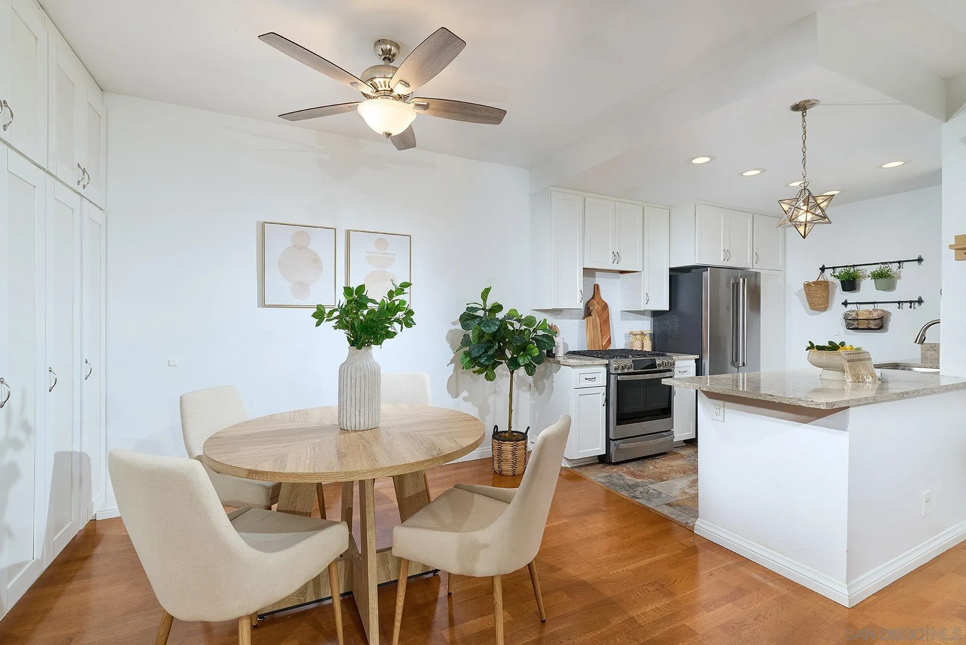 13826 Midland Road Poway, CA 92064 - Photo 9 of 38 a dining room with kitchen island stainless steel appliances furniture a chandelier and a view of kitchen