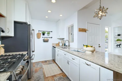 a kitchen with sink stove and refrigerator