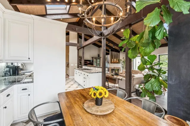 a dining room with furniture and a potted plant