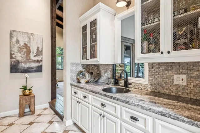 a kitchen with stainless steel appliances granite countertop a sink and a granite counter tops