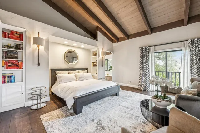 a bedroom with furniture and a large window