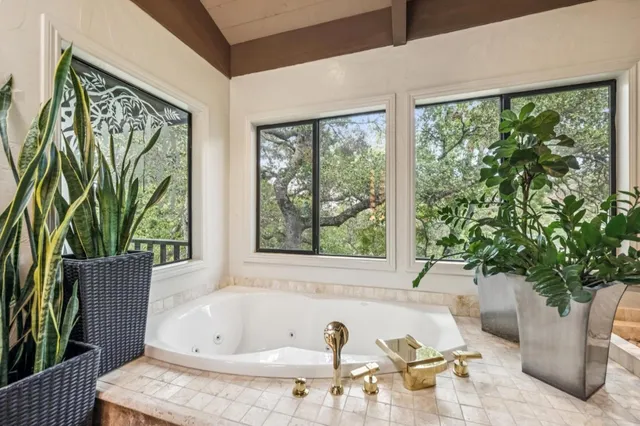 a white bath tub sitting in front of a window