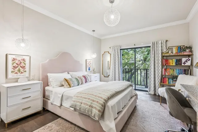 a bedroom with bed wooden floor and window