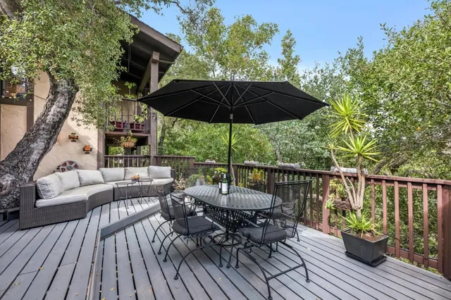 a view of balcony with furniture and umbrella