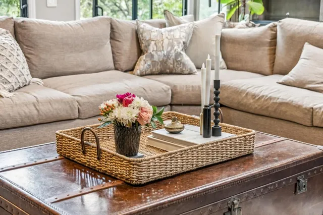 a living room with furniture and flower pot