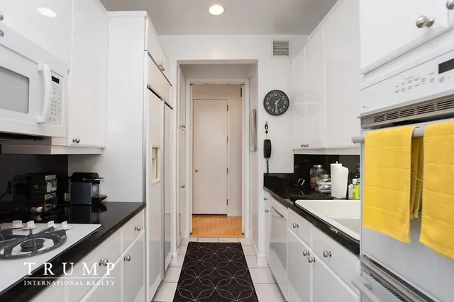 a kitchen with stainless steel appliances a sink a stove and a refrigerator