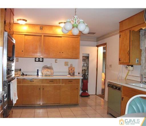 21 Highland Road Colonia, NJ 07067 - Photo 3 of 10 a kitchen with stainless steel appliances granite countertop a sink and a refrigerator