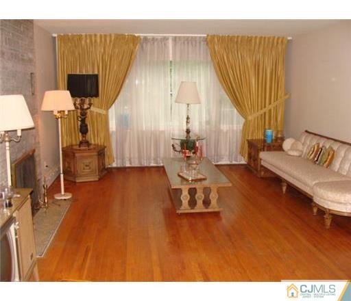 21 Highland Road Colonia, NJ 07067 - Photo 4 of 10 a living room with a couch and a table