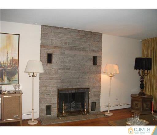 21 Highland Road Colonia, NJ 07067 - Photo 6 of 10 a living room with furniture and a fireplace