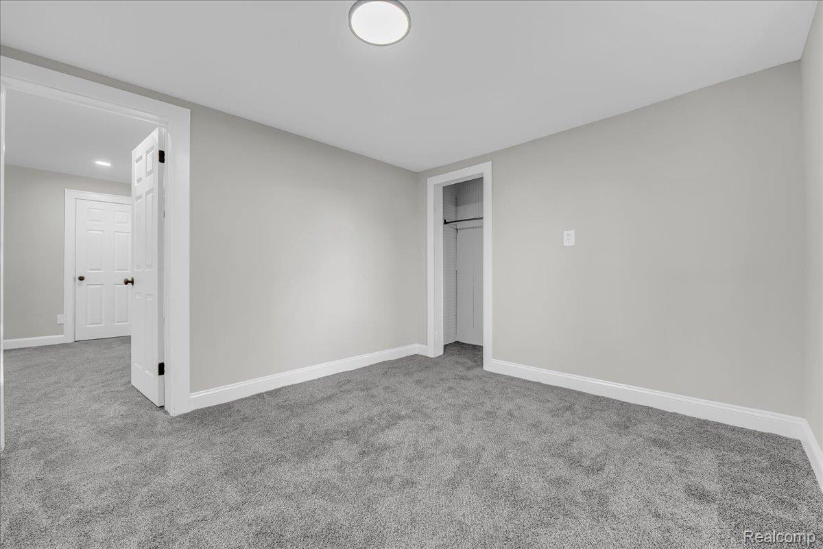 16717 Fielding Street Detroit, MI 48219 - Photo 36 of 46 Unfurnished bedroom with light colored carpet and a closet