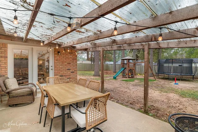 a view of a patio with a table and chairs