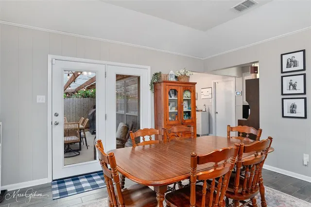 a dining room with furniture and wooden floor