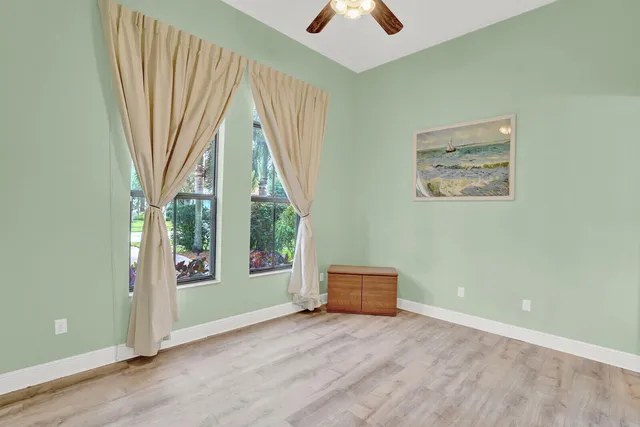 a spacious bedroom with a large bed and a large window