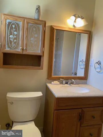 a bathroom with a toilet sink and mirror