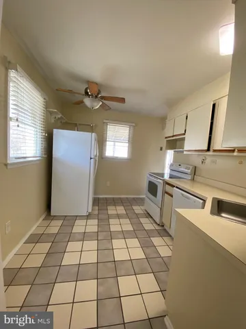 a kitchen with a sink a stove and cabinets