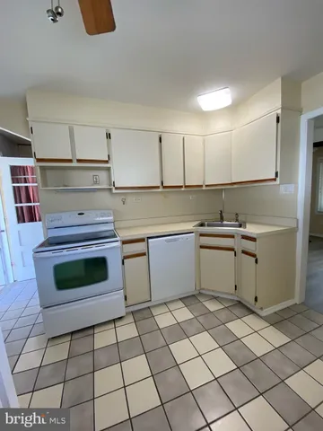 a kitchen with a stove a sink and a refrigerator