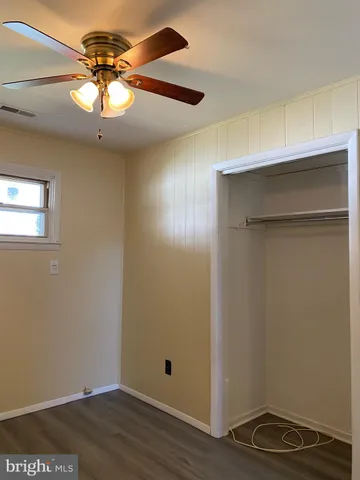 a view of room with hardwood floor and ceiling fan