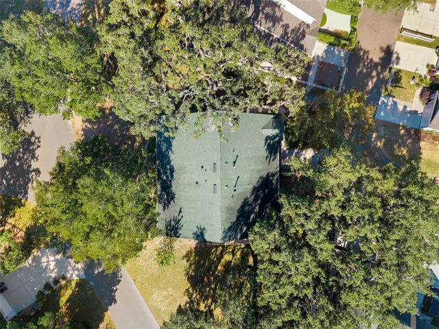 an aerial view of a house with yard swimming pool and outdoor seating