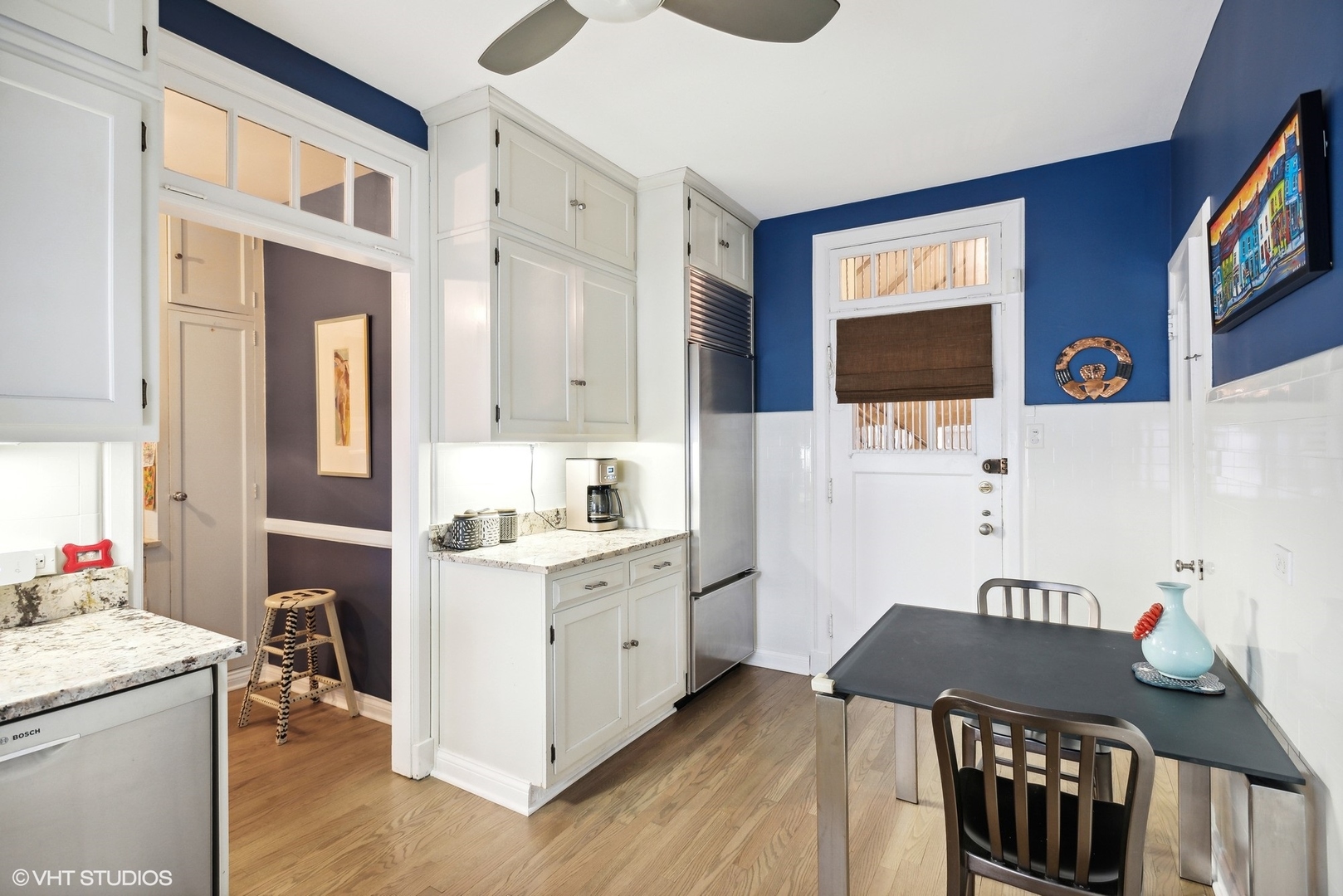 200 Lee Street, Unit 1B Evanston, IL 60202 - Photo 12 of 26 a kitchen with stainless steel appliances kitchen island granite countertop a stove a sink and white cabinets