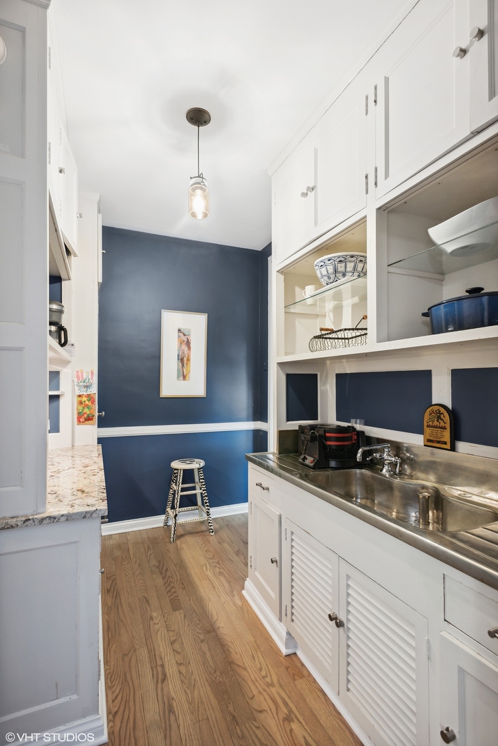 200 Lee Street, Unit 1B Evanston, IL 60202 - Photo 13 of 26 a kitchen with stainless steel appliances granite countertop a sink and cabinets