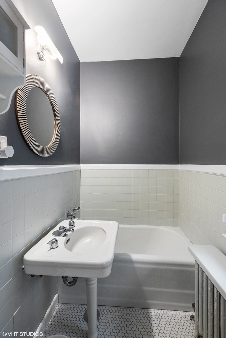 200 Lee Street, Unit 1B Evanston, IL 60202 - Photo 21 of 26 a bathroom with a sink a toilet and a mirror