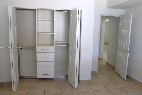 a kitchen with stainless steel appliances kitchen island granite countertop a refrigerator a stove and a sink