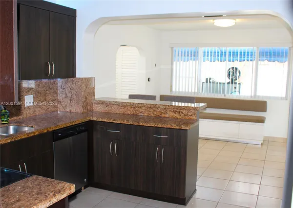 a kitchen with a dining table and chairs