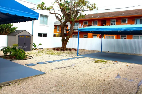 a view of a backyard of a house with a patio
