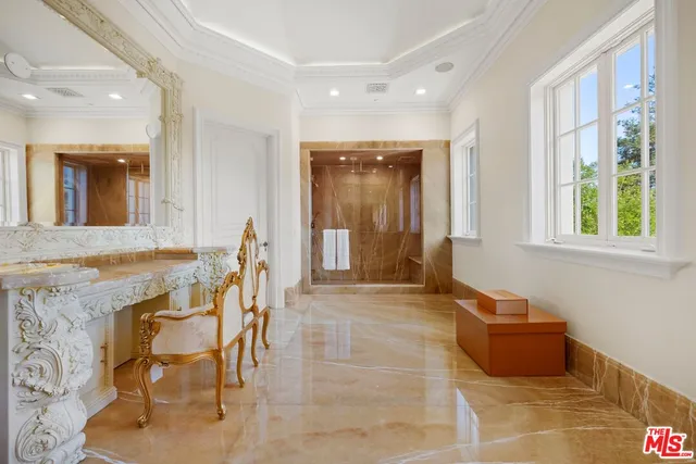a spacious bathroom with a tub sink and mirror