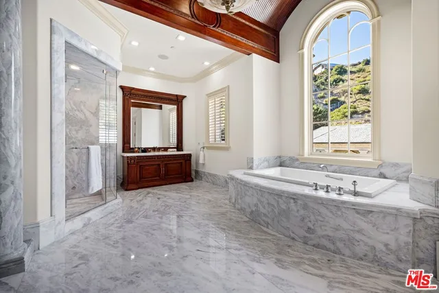 a living room with patio furniture and a large window