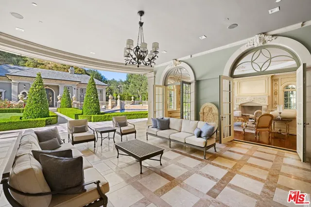 a view of a house with backyard porch and sitting area