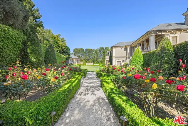 a front view of a residential houses with yard and green space