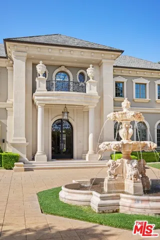 a view of a house with swimming pool and sitting area