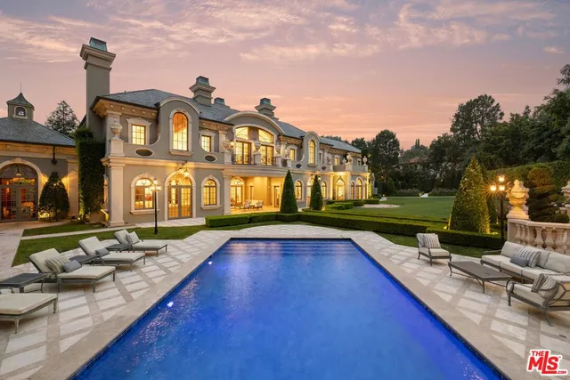 an aerial view of a house with table and chairs