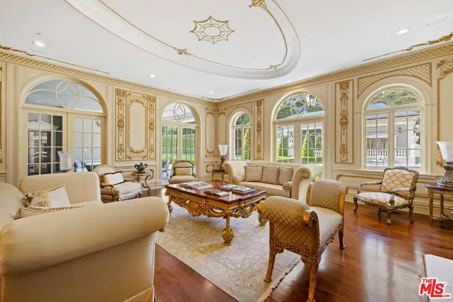 a living room with furniture fireplace and a large window