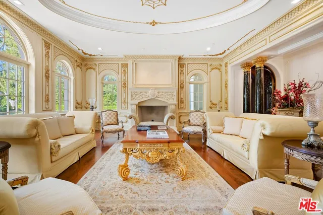 a living room with furniture fireplace and a large window