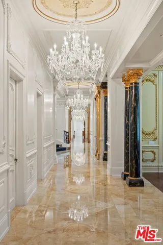 a large white kitchen with lots of counter space a sink and appliances