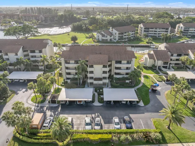 an aerial view of residential houses with outdoor space and swimming pool