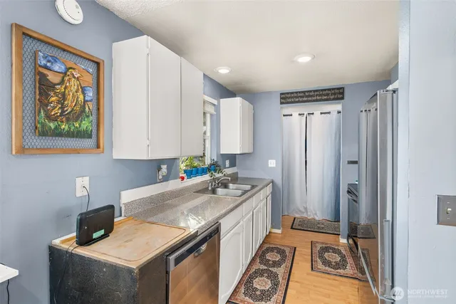a kitchen that has a sink a refrigerator and a stove in it