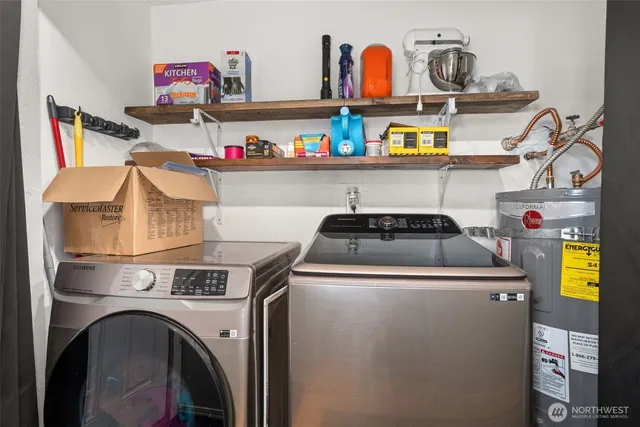 a utility room with dryer washer and shoe rack