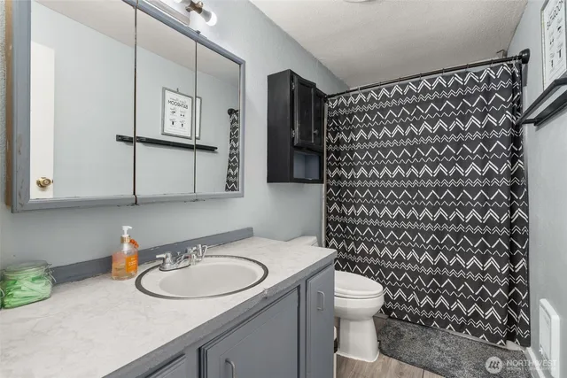 a bathroom with a sink toilet and shower