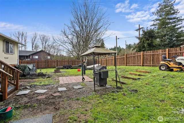 a view of a house with a yard patio and slide