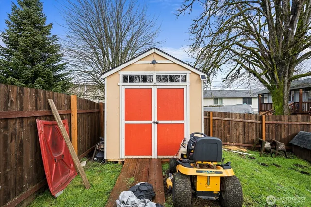 a view of a backyard with a small cabin and a chair