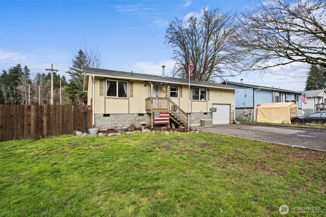 a view of a house with backyard and sitting area