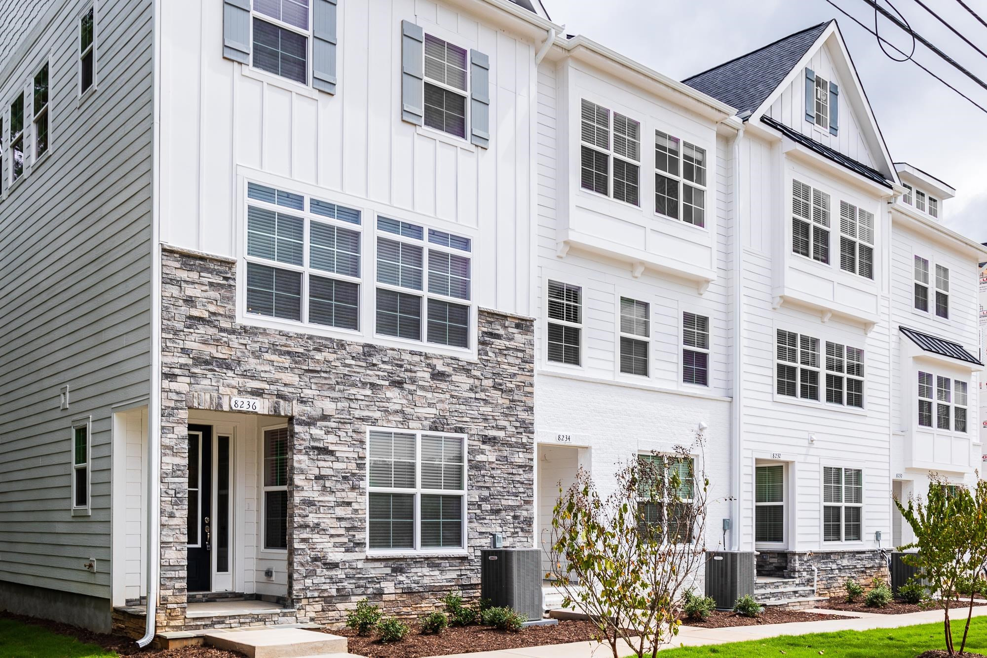 a front view of a building with a garden