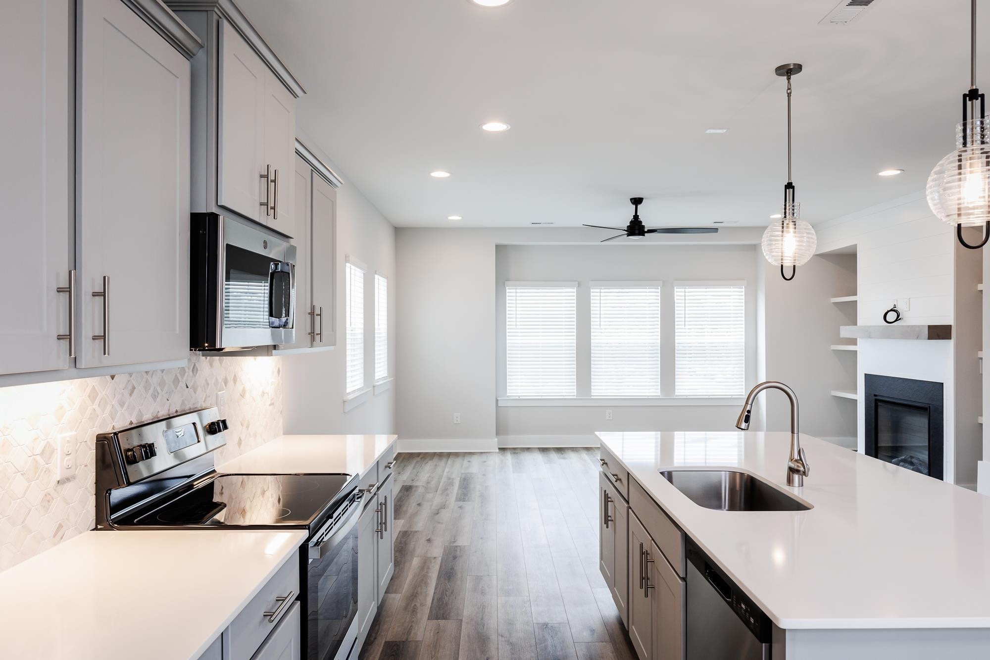 8222 Ebenezer Church Road Raleigh, NC 27613 - Photo 2 of 18 a kitchen with granite countertop a stove sink and microwave