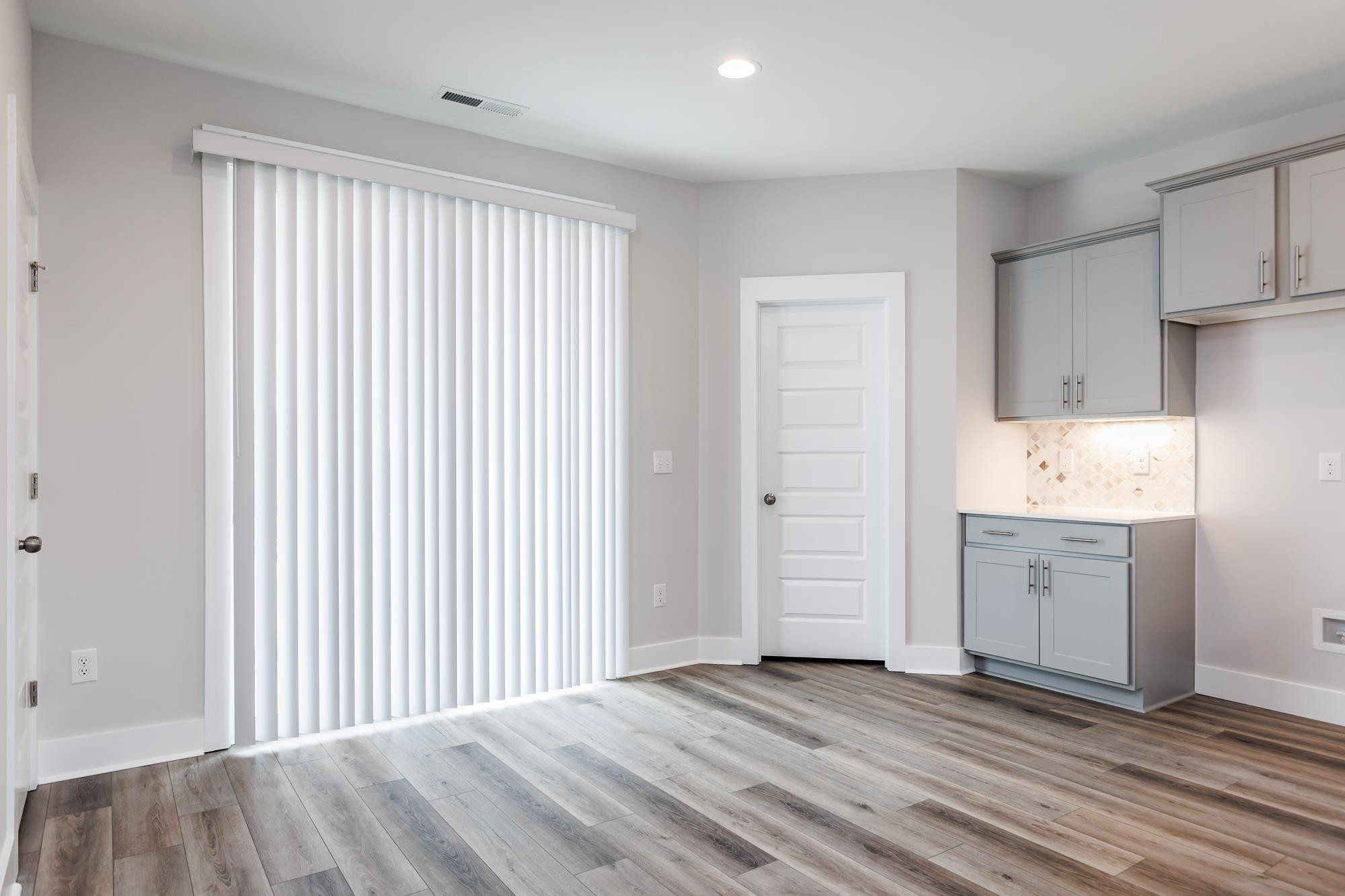 8222 Ebenezer Church Road Raleigh, NC 27613 - Photo 3 of 18 a view of a kitchen with wooden floor and a sink