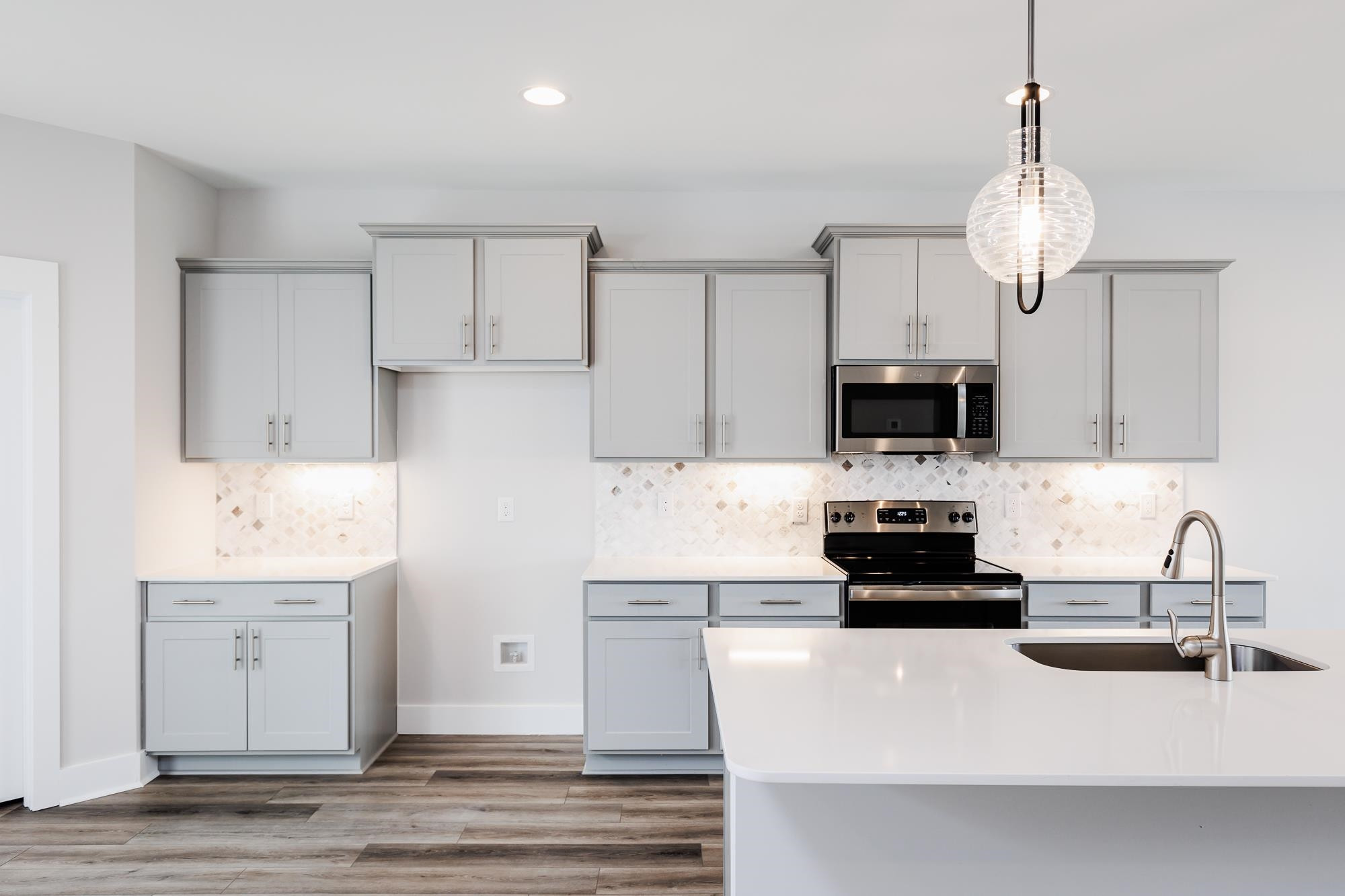 8222 Ebenezer Church Road Raleigh, NC 27613 - Photo 4 of 18 a kitchen with stainless steel appliances a stove sink and refrigerator